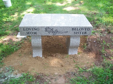 A bench with a rose design and a few other words written on it